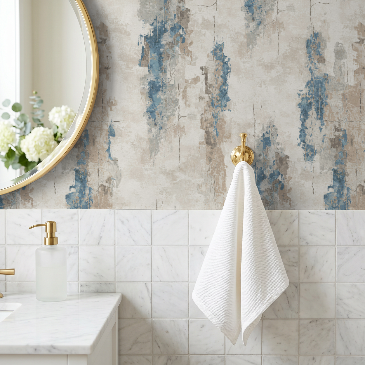 Abstract blue and taupe brushstroke wallpaper in a bathroom with gold accents.