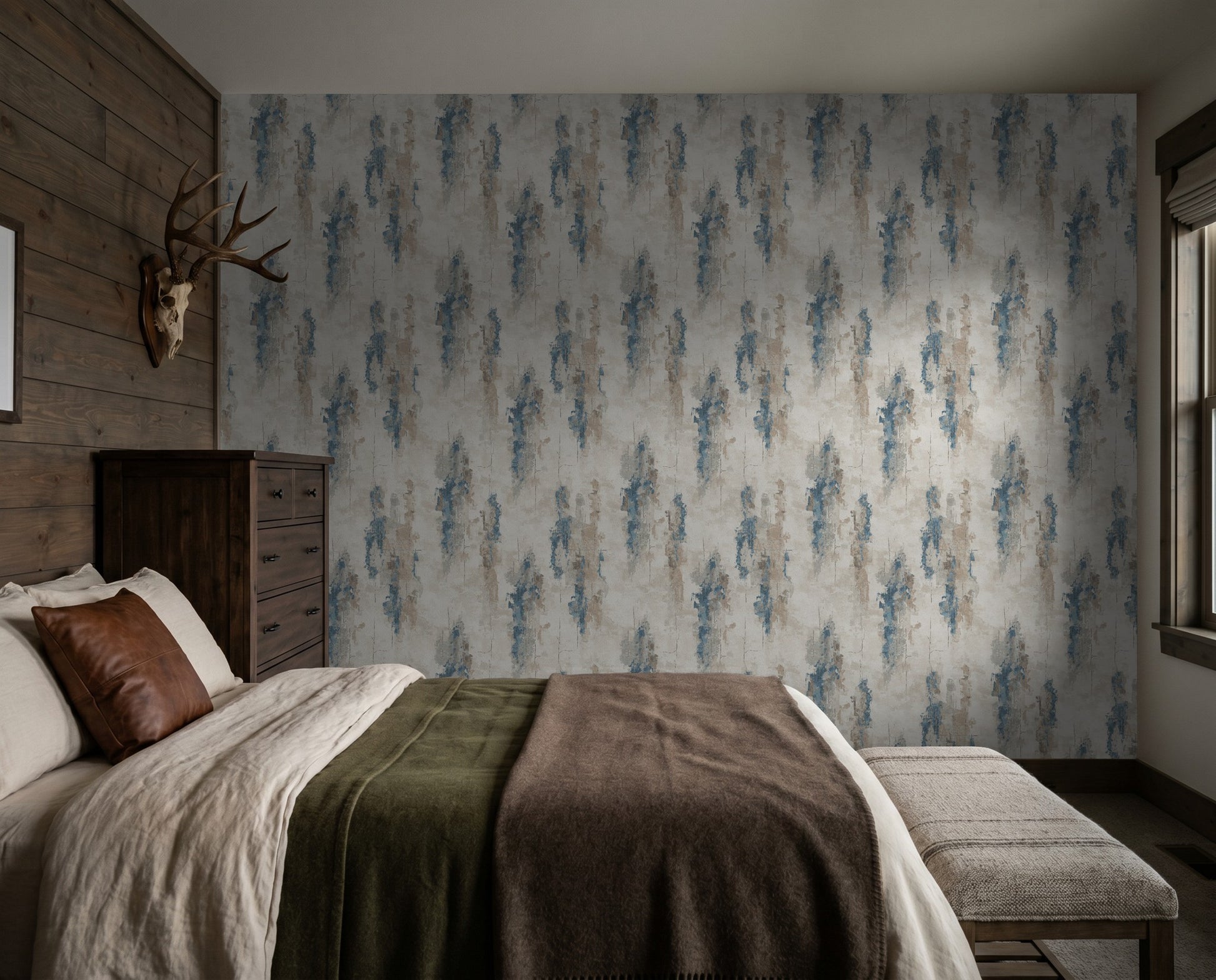 Abstract blue and taupe brushstroke wallpaper in rustic bedroom setting.