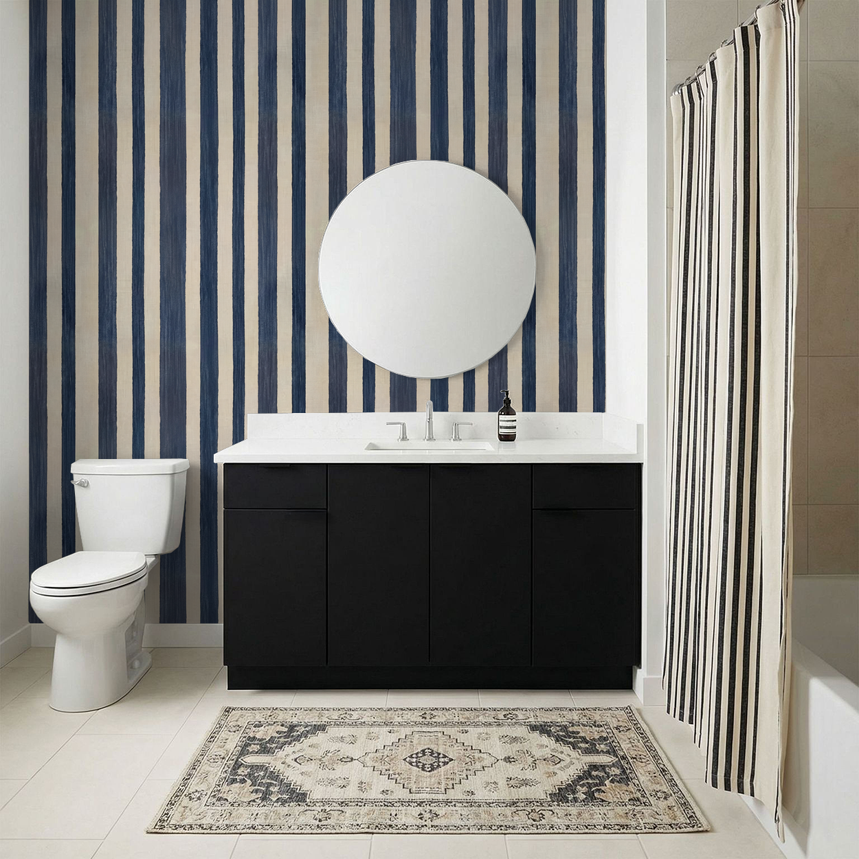 Bathroom with blue and beige vertical stripe wallpaper, modern vanity, round mirror.