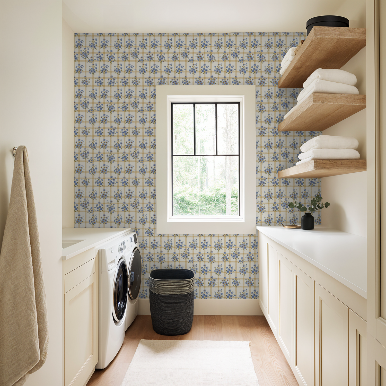 Laundry room with blue floral wallpaper featuring ivory and gold grid pattern.