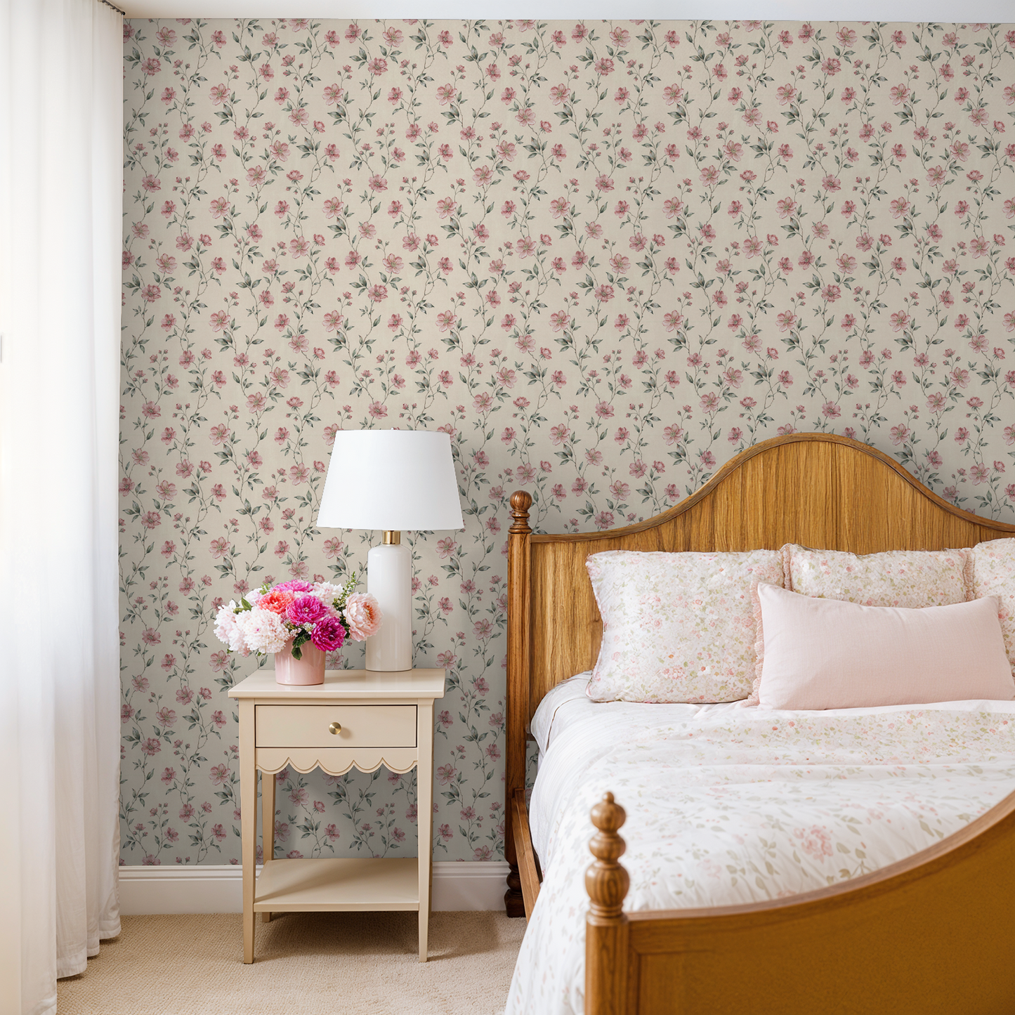 Blush floral wallpaper in cozy bedroom with wooden bed and nightstand.