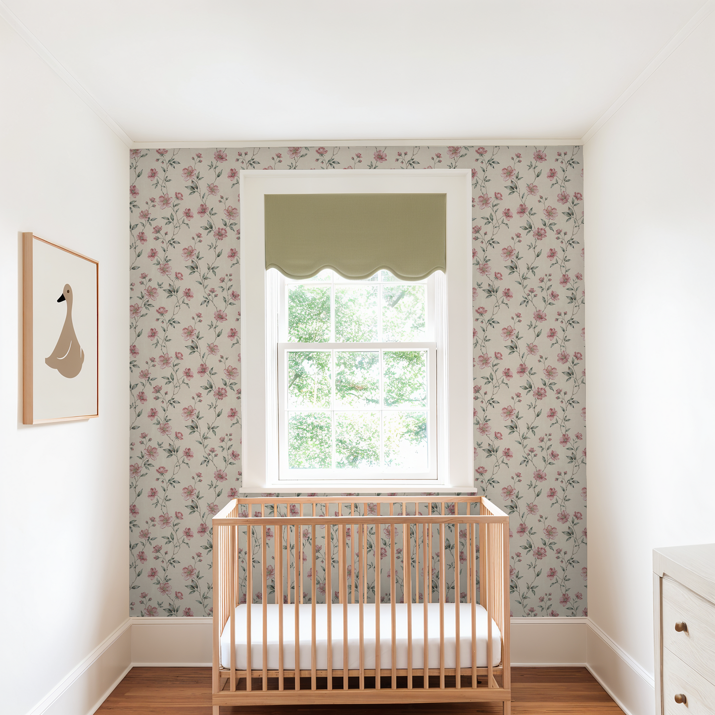 Blush floral wallpaper in nursery with wooden crib and window.