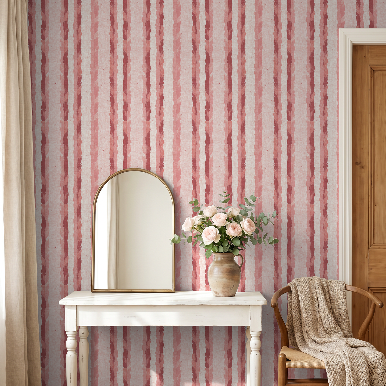 Blush and rose striped wallpaper with feather motifs in cozy room with mirror and flowers.