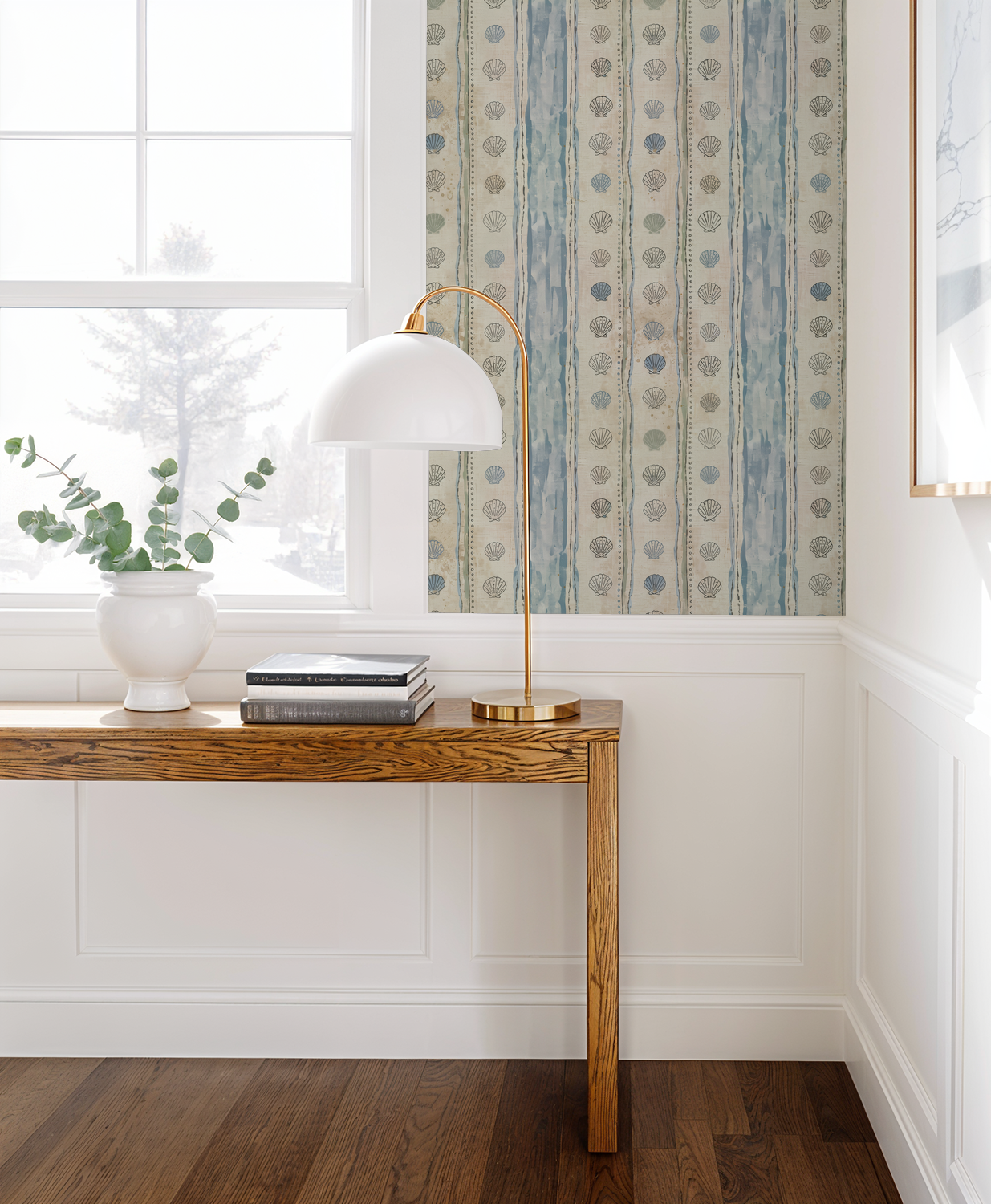 Coastal seashell and stripe wallpaper in serene living room setting.