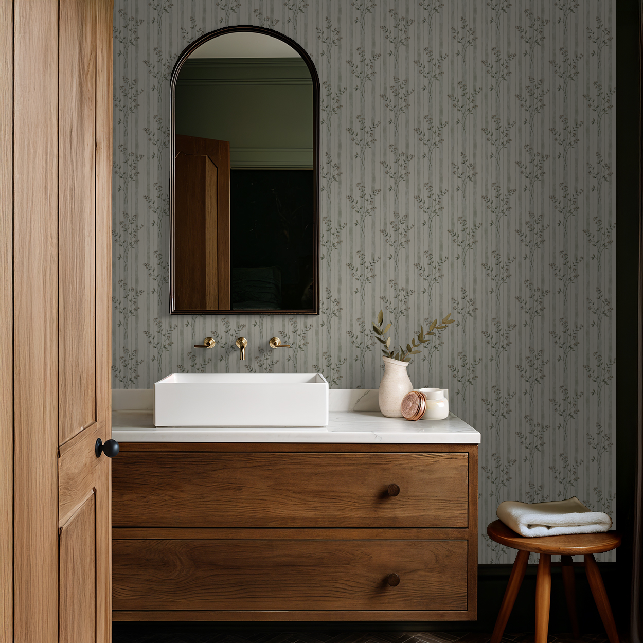 Elegant floral striped wallpaper in a rustic bathroom with wooden vanity.