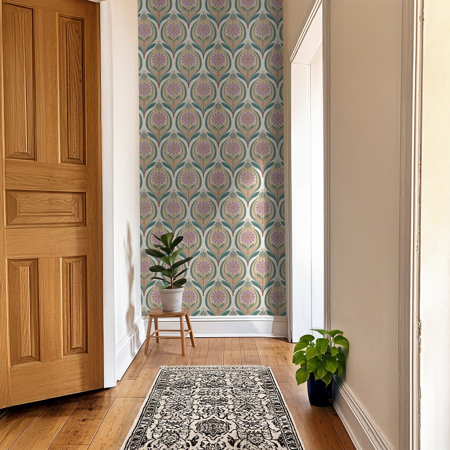 Flora Mae lilac floral and teal leaf wallpaper in a bright hallway with plants.