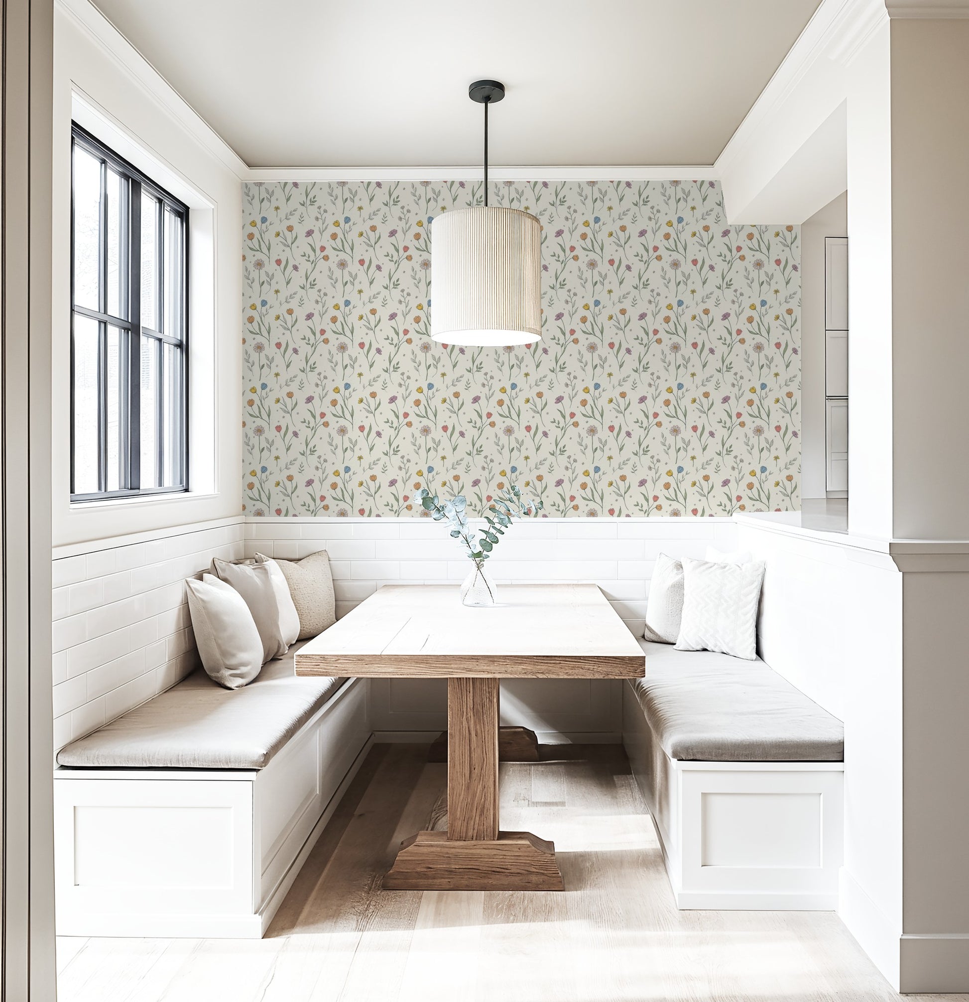 Floral wallpaper with pastel tulips in cozy dining nook with wood table.