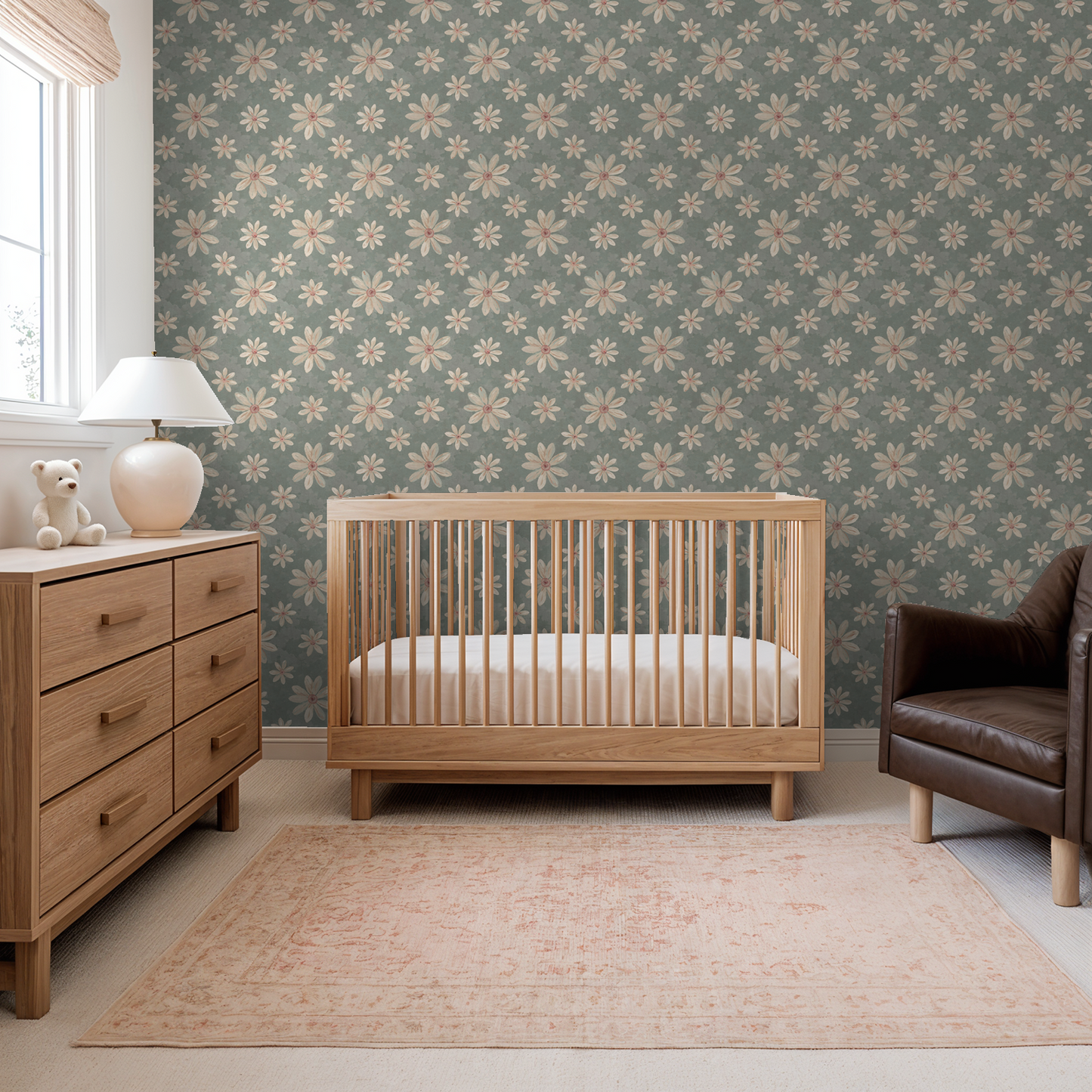 Nursery with floral wallpaper featuring creamy white and dusty pink flowers on a sage background.