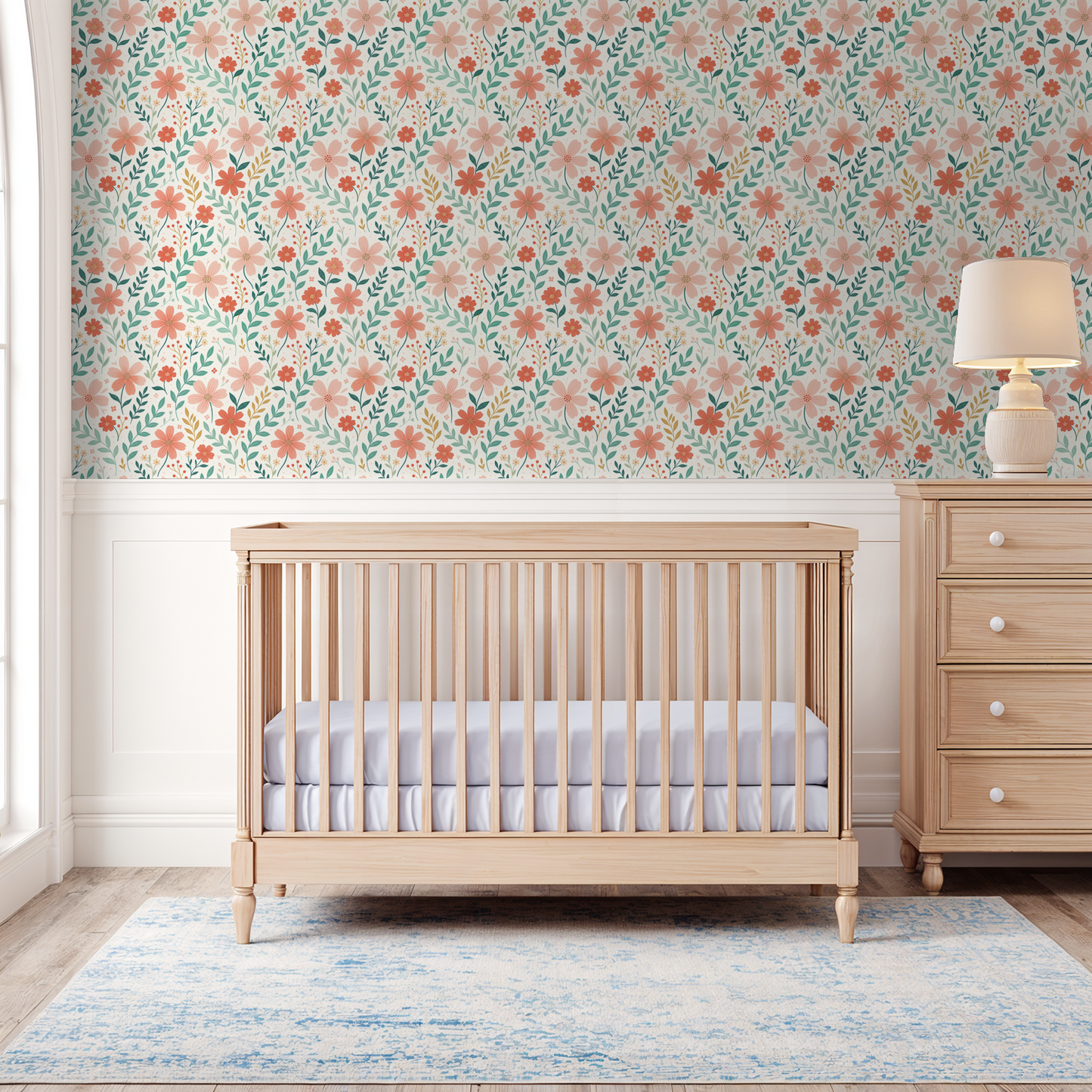 Floral wallpaper with peach and coral blooms in a nursery setting with crib and dresser.