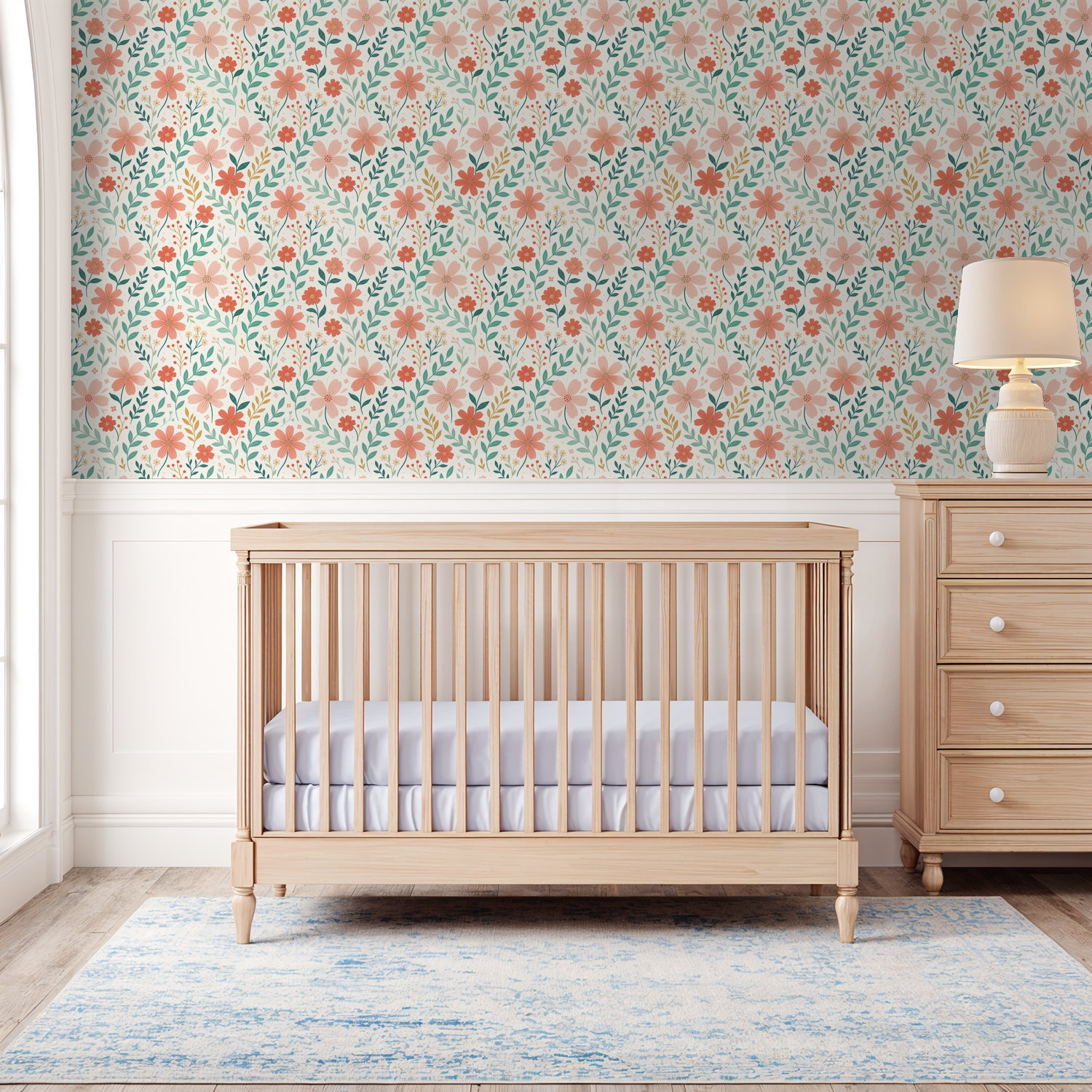 Floral wallpaper with peach and coral blooms in a nursery setting with crib and dresser.