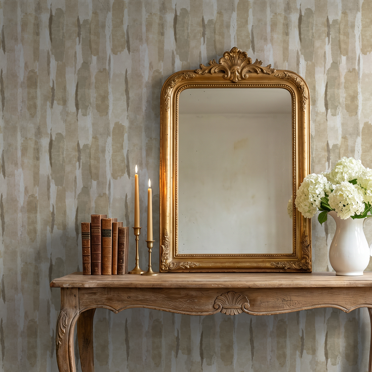 Gold Sweep wallpaper with earthy tones behind ornate mirror and table with candles and flowers.