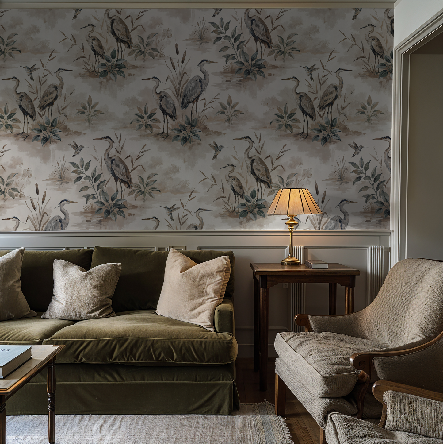 Heron Bay wallpaper with herons and foliage in taupe, sage, and dusty blue in a cozy living room.