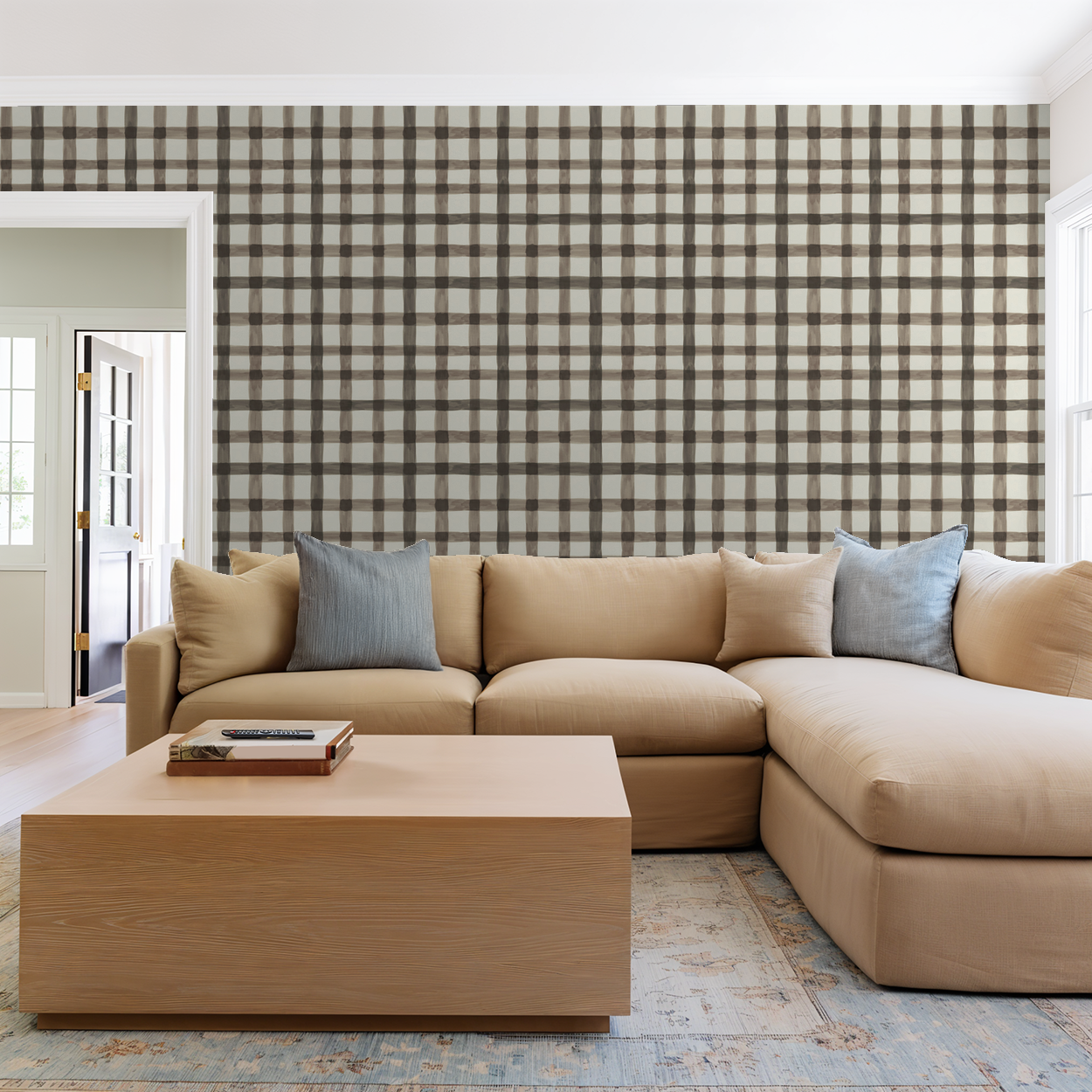 Latticed Autumn plaid wallpaper in muted browns and creams in a cozy living room with beige sofa.