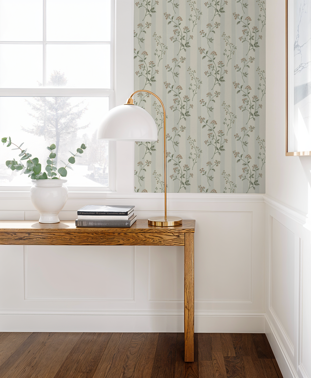 Leaf & Stripe wallpaper with delicate sprigs and stripes in a bright room with wooden table.