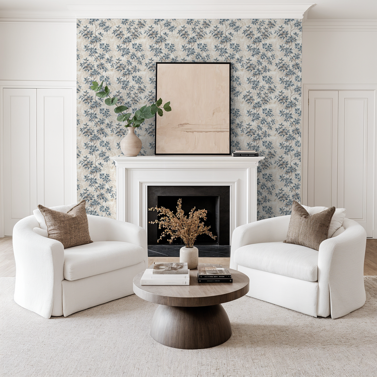 Living room with Leafy Daydreams wallpaper, blue floral pattern, white chairs, and fireplace.