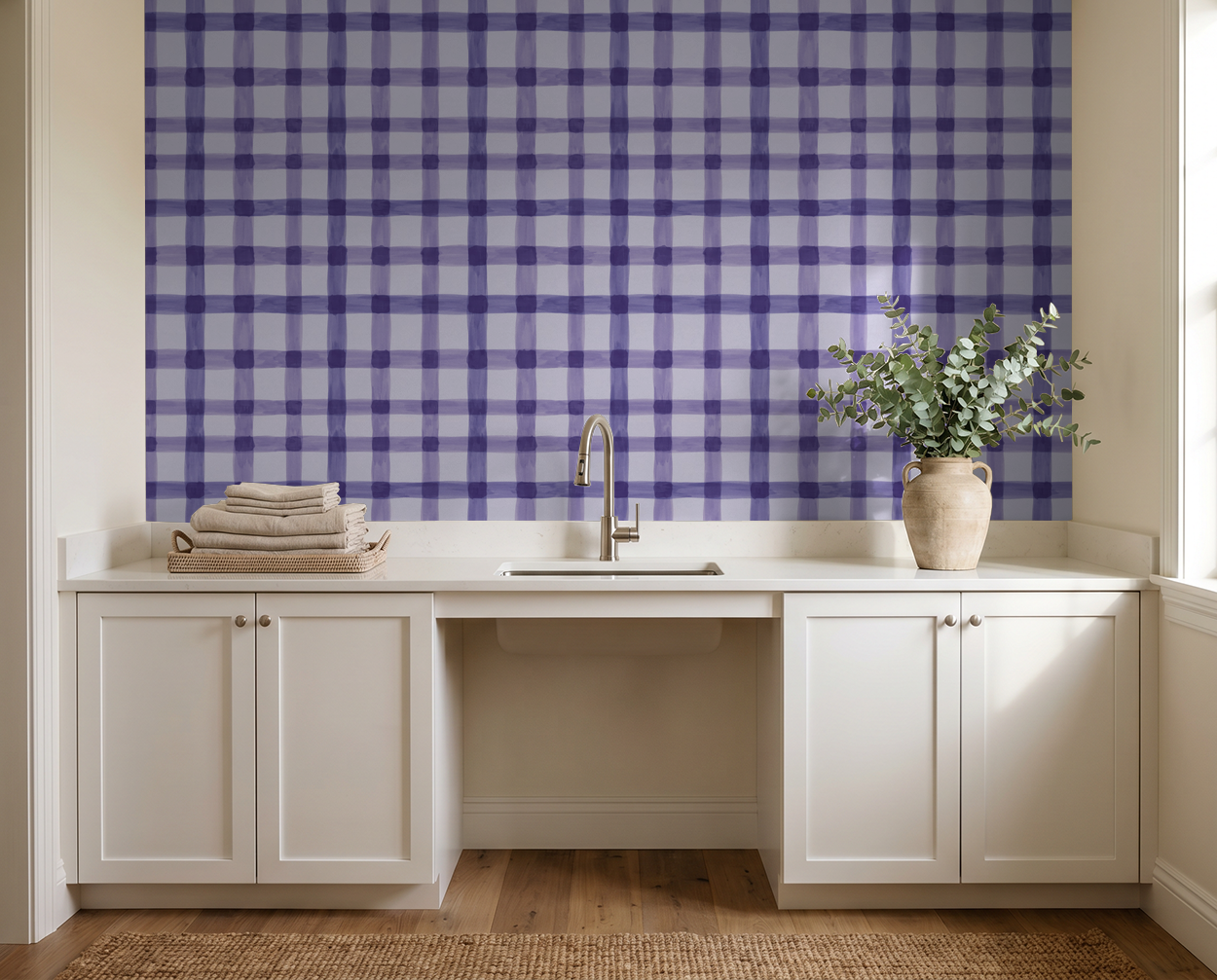 Lilac and violet plaid wallpaper in a modern kitchen setting with white cabinets and sink.