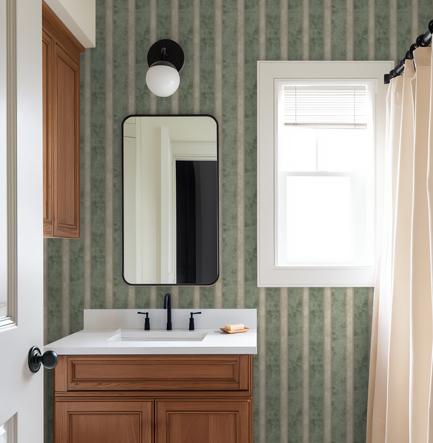 Bathroom with muted sage and cream striped wallpaper, wood vanity, and mirror.