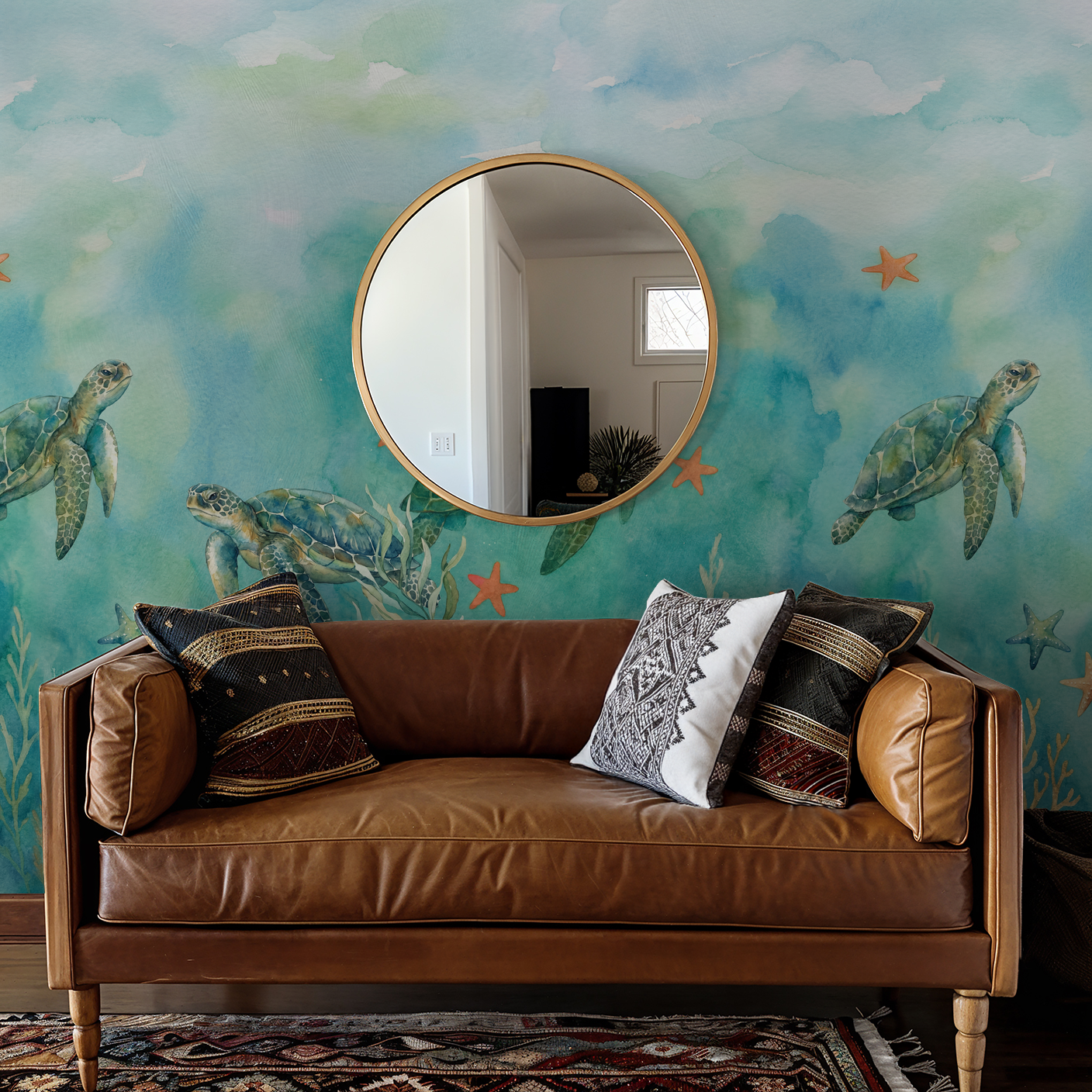 Oceaneer wallpaper with turtles, coral, and starfish in aquamarine tones behind a brown leather sofa.