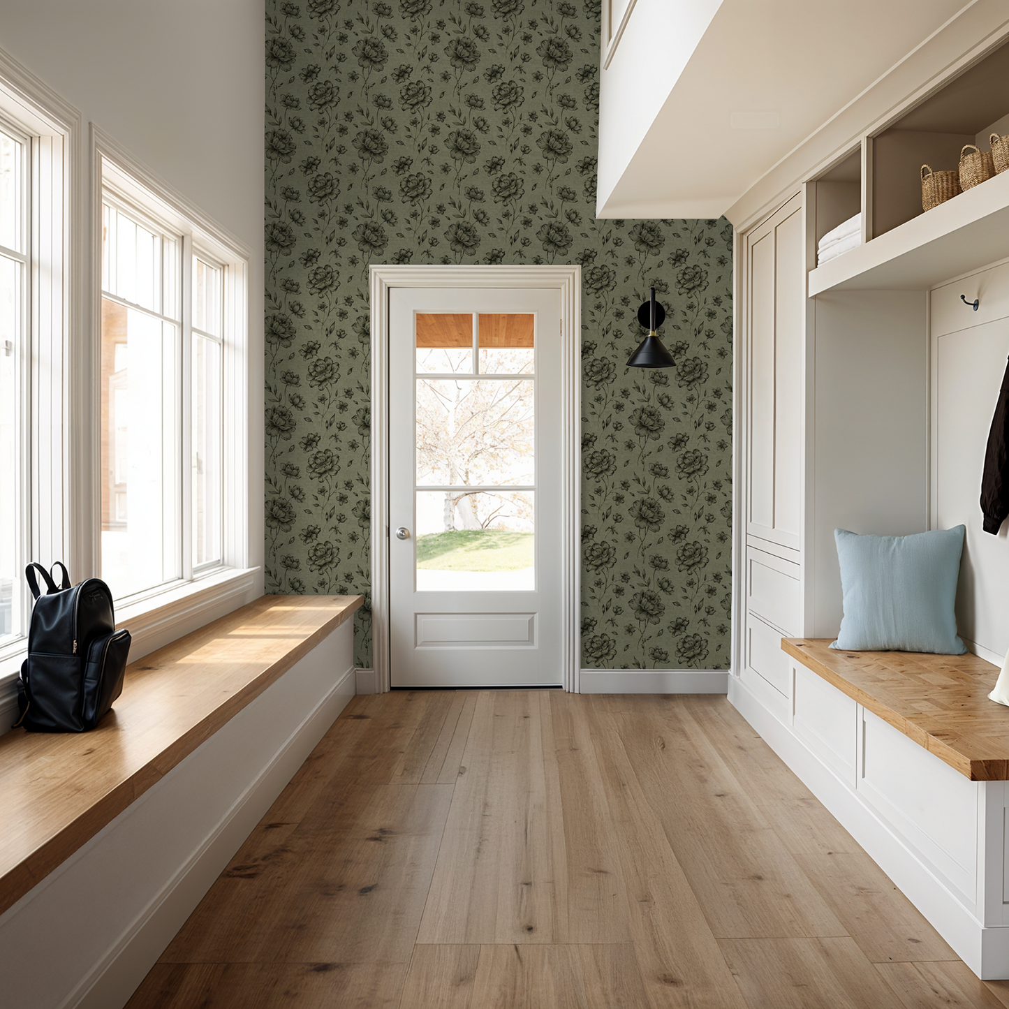 Olive floral Jardin Noir wallpaper in a bright entryway with wood accents.