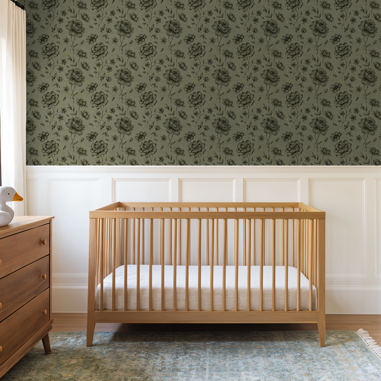 Olive wallpaper with charcoal floral pattern in nursery with wooden crib.