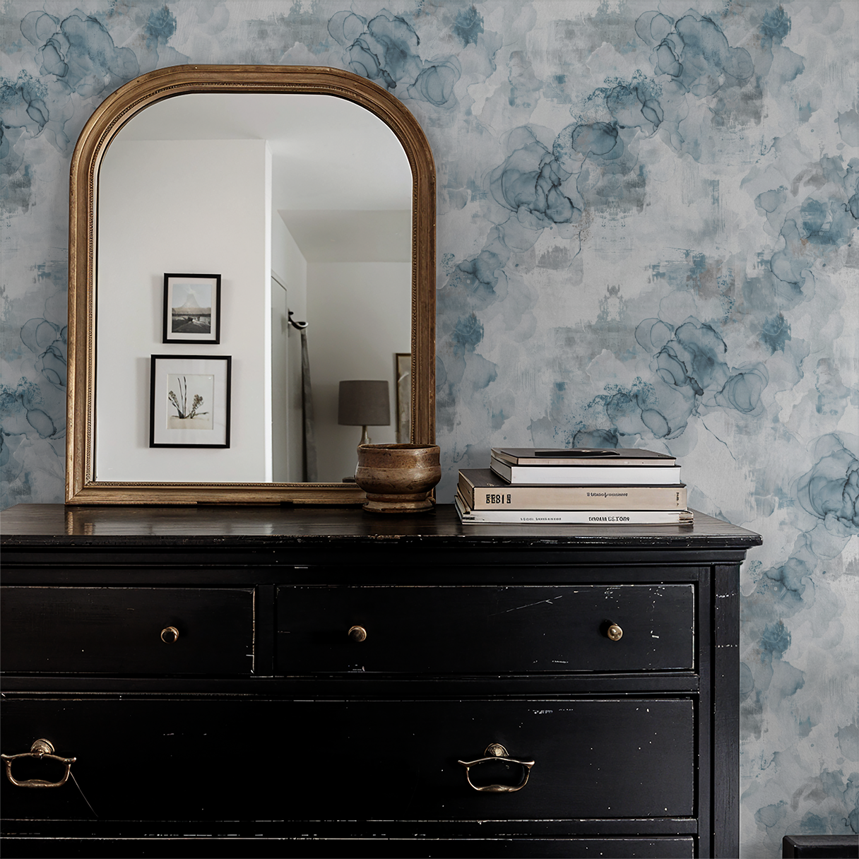 Parisian Mist watercolor wallpaper in blue and gray behind vintage mirror and dresser.