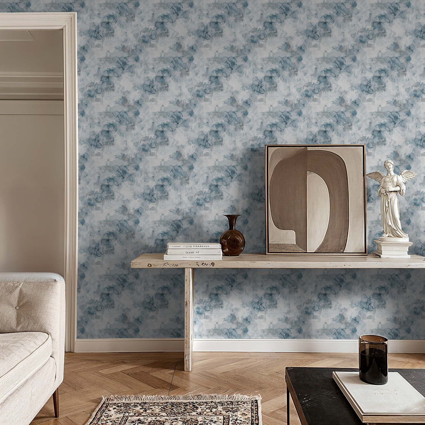 Parisian Mist watercolor wallpaper in soft blues and grays in a chic living room.