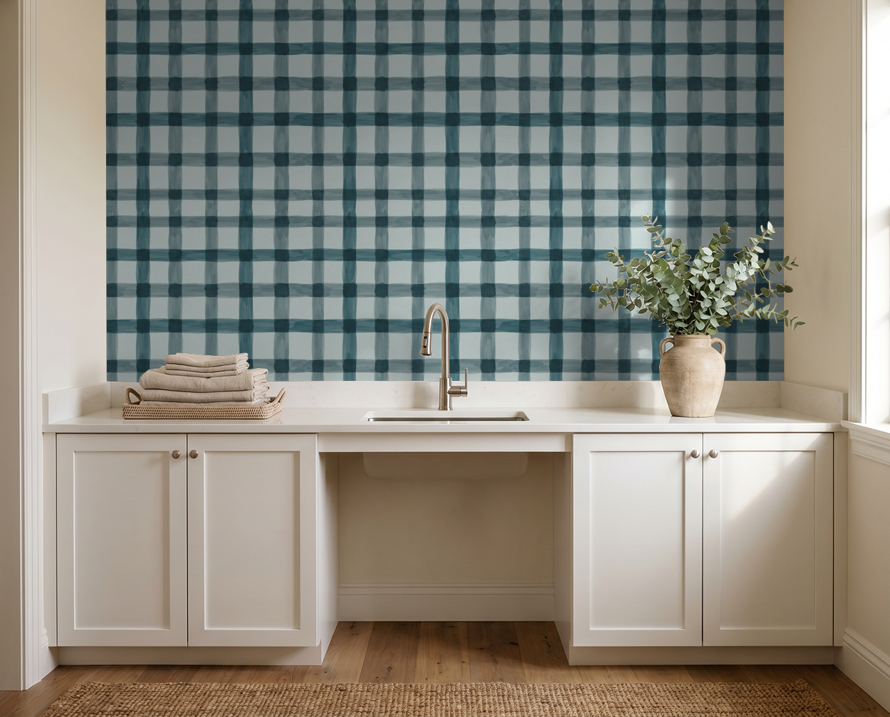 Plaid blue and white wallpaper in a modern kitchen with white cabinets and wooden decor.