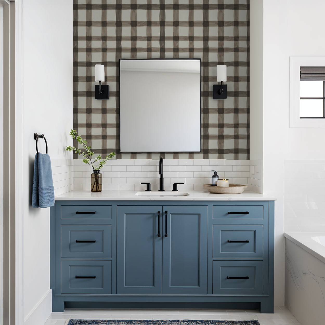 Plaid wallpaper with muted browns and creams in a modern bathroom with blue vanity.
