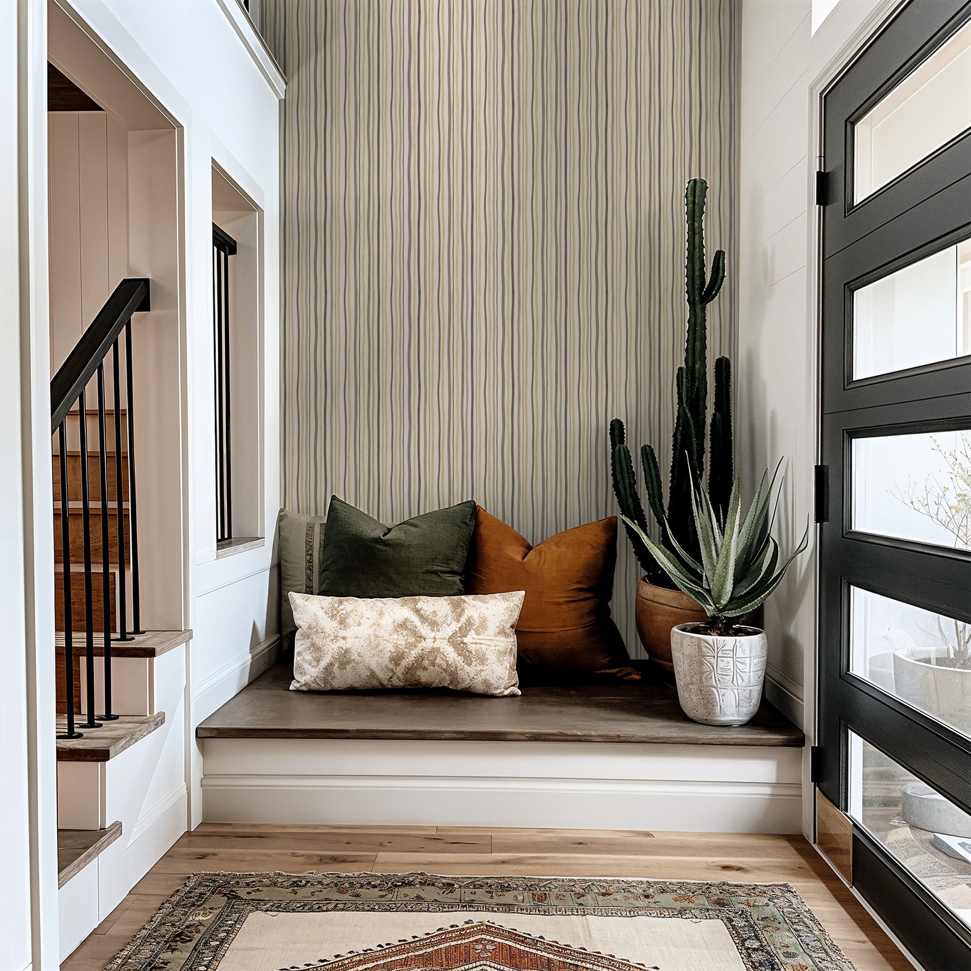 Refined Rhythm wallpaper with flowing vertical lines in beige and taupe in a cozy entryway.