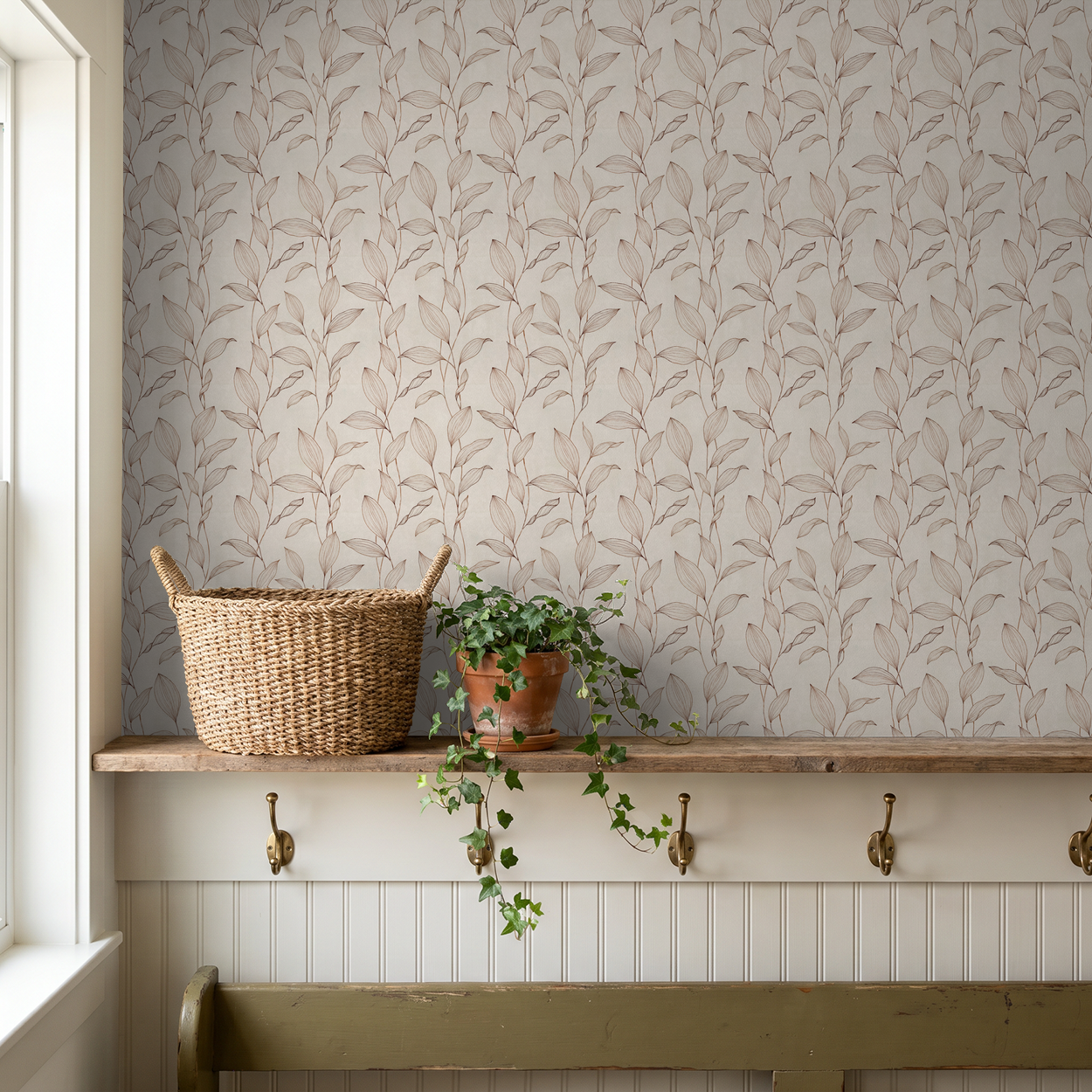 Sepia-toned botanical wallpaper in a cozy room with basket and plant.