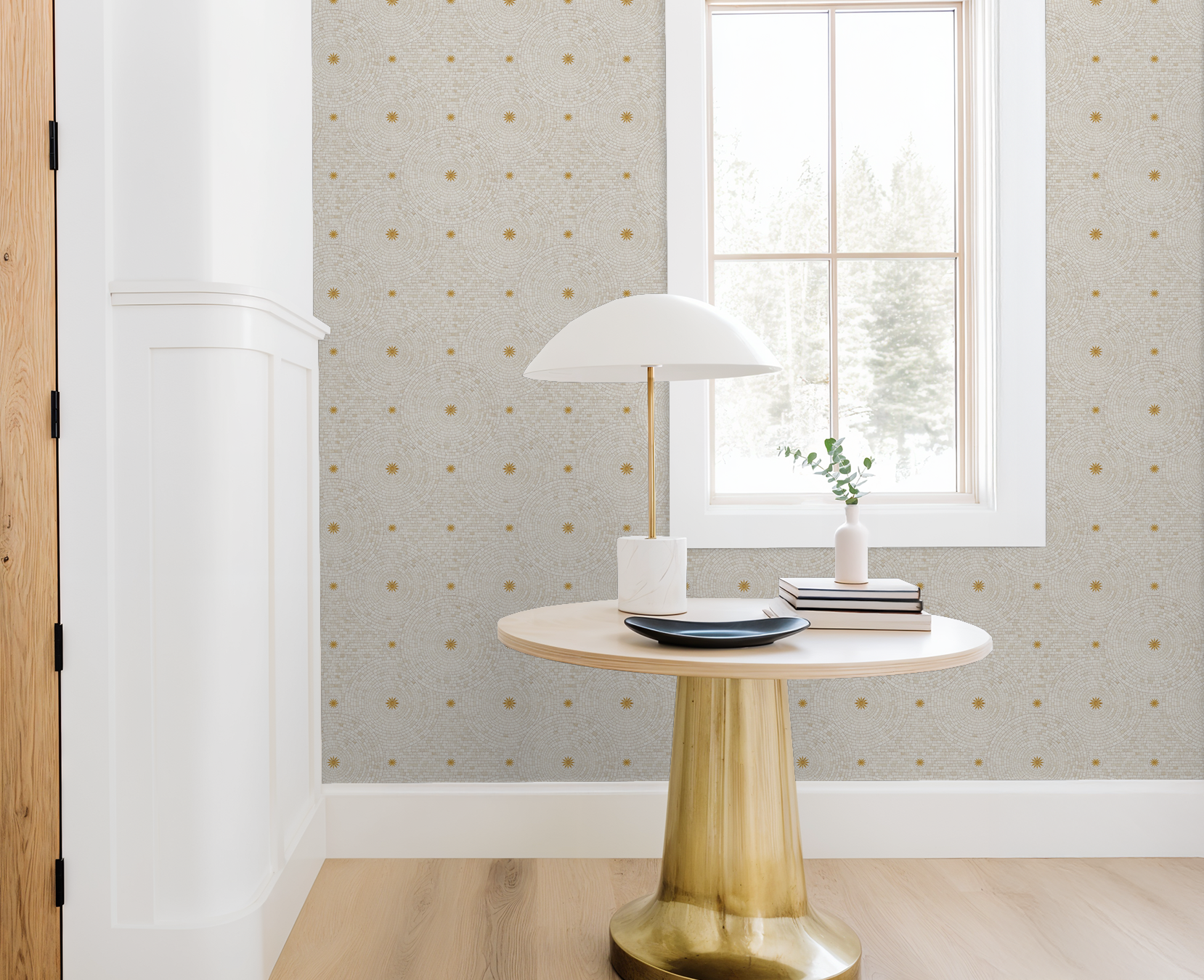 Tiled Sunshine wallpaper with gold starbursts in a bright, modern room with round table and lamp.