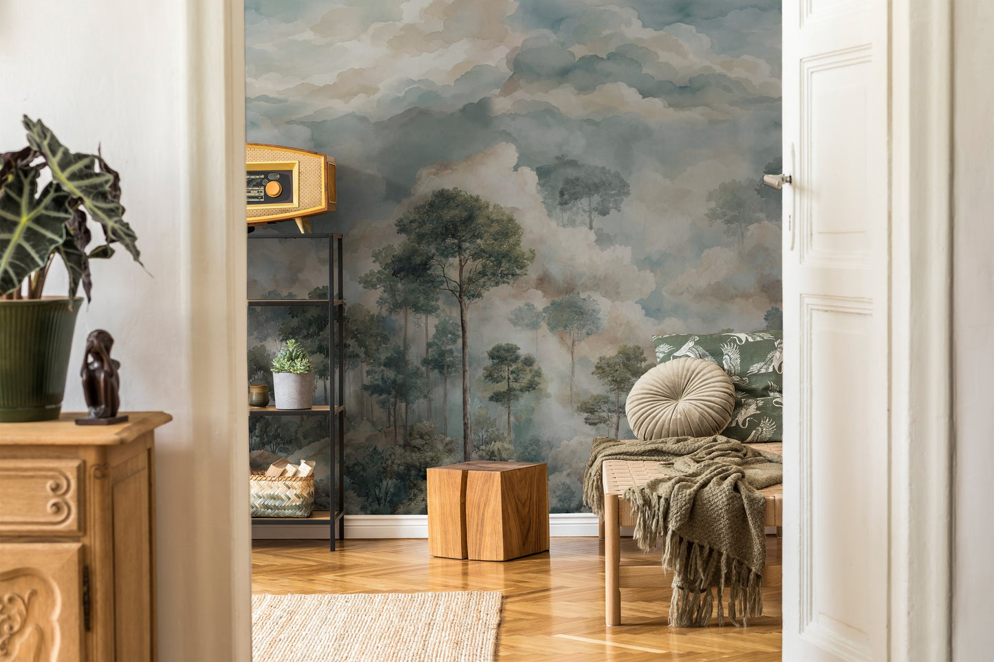 Tranquil forest dreamscape wallpaper in muted greens and blues in a cozy living room.