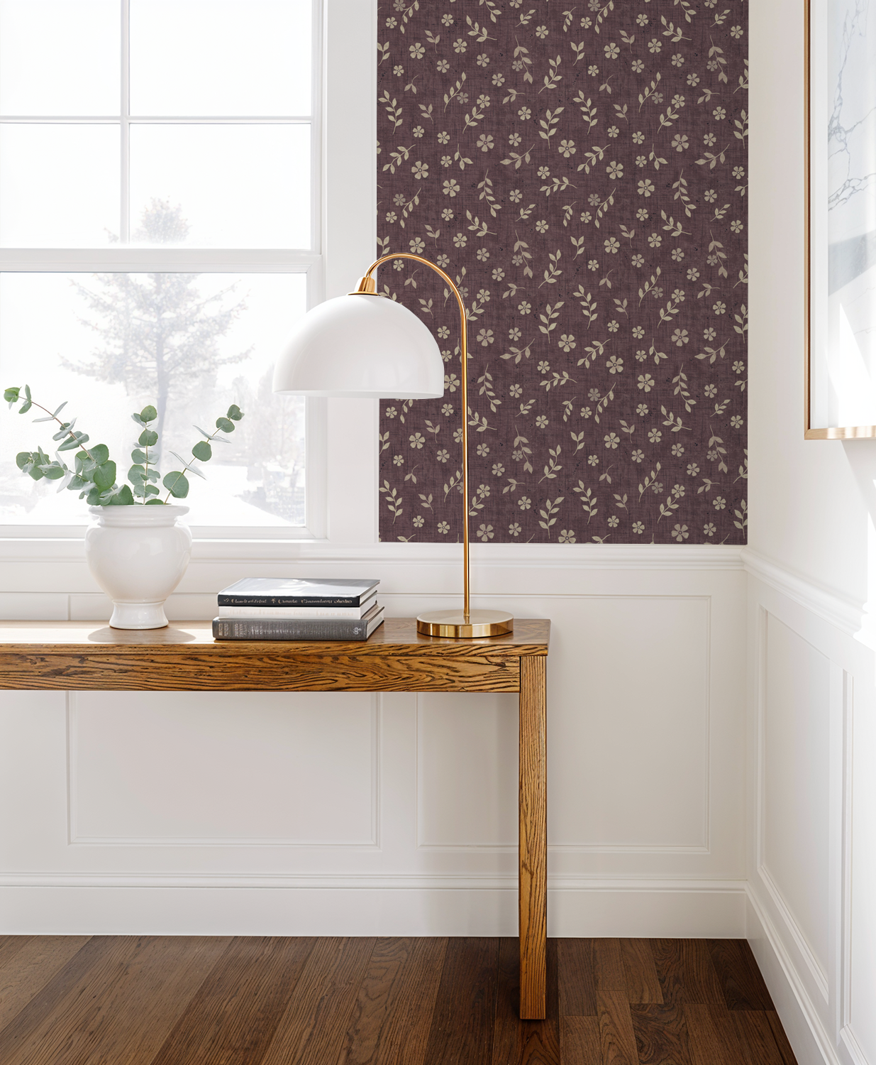 Vintage plum floral wallpaper in elegant room with wooden console and white lamp.
